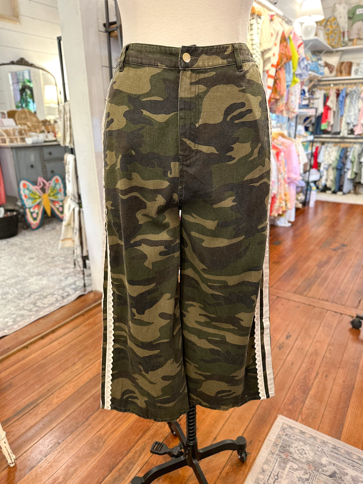 Camouflage pants on a mannequin in a store setting