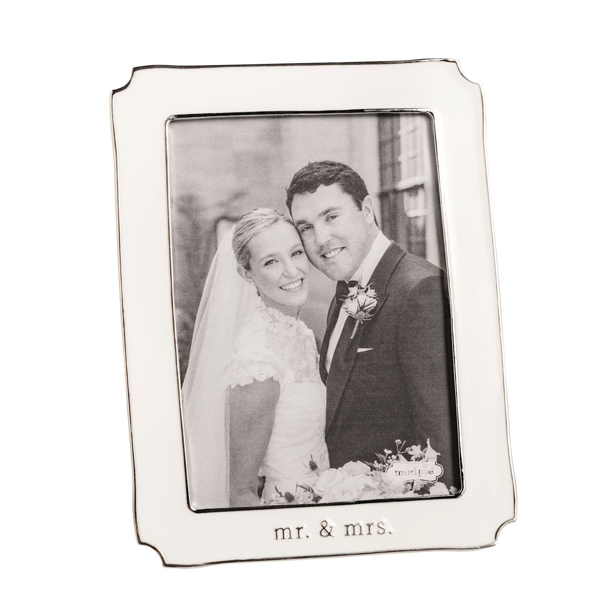 Silver and white enamel photo frame with 'Mr. & Mrs.' engraving, containing a wedding photo of a couple.