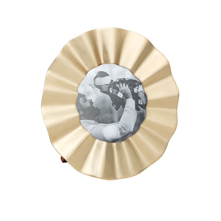 brass circular photo frame with a black and white photo of a person holding a camera.