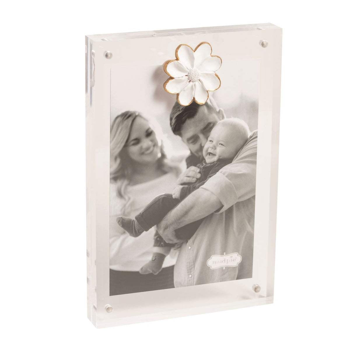 White photo album with a floral design on top, containing a family photo of a couple and child.
