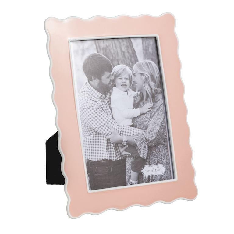 Pink photo frame with a family photo inside on a white background