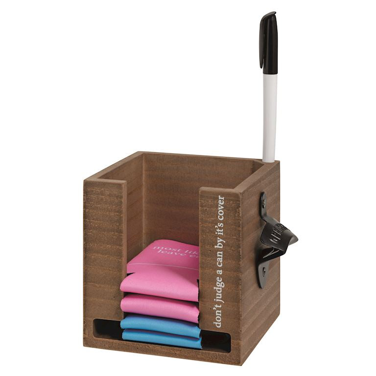 Wooden holder with pink and blue can holder inside on a white background