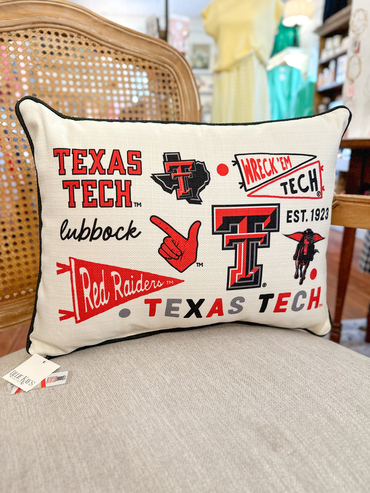 Texas Tech pillow with multiple logos on a couch