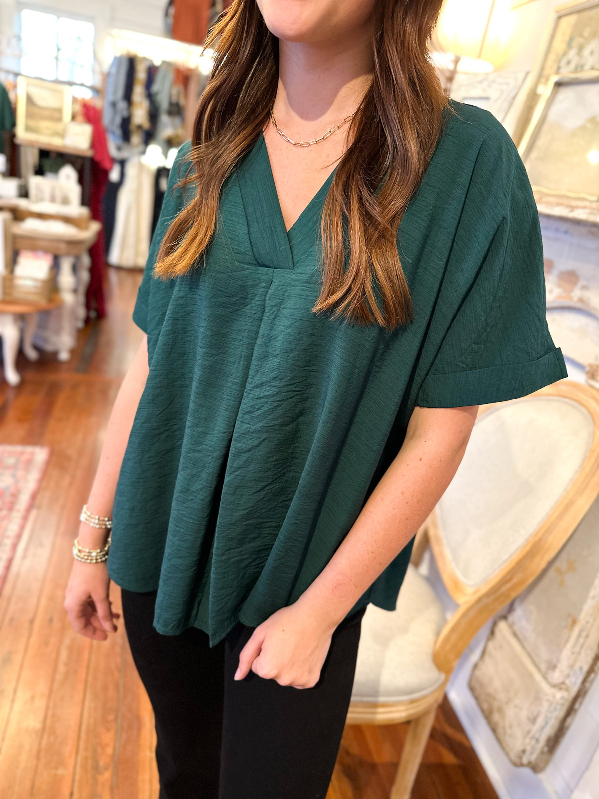 dark green rolled sleeve top with flowy fit 