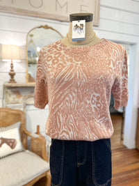 Mannequin wearing a patterned top inside lillie kays 
