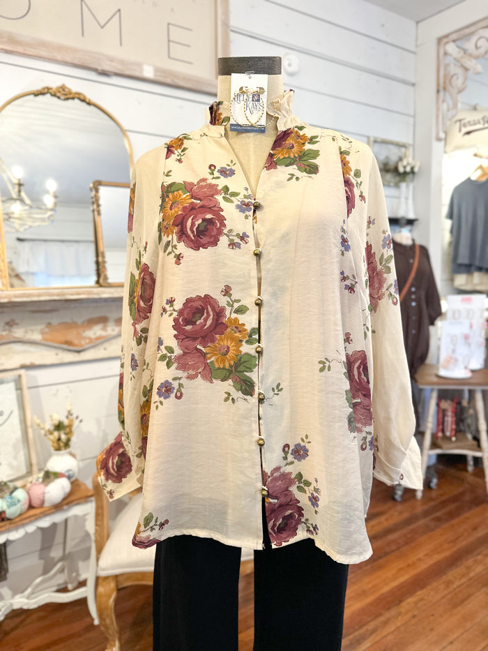 Floral cardigan on a mannequin in a store setting