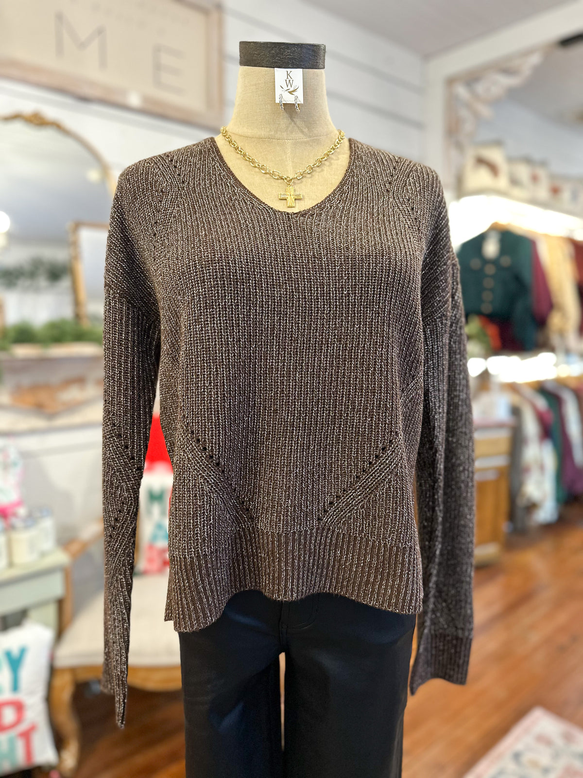 Brown sweater on a mannequin in a store setting