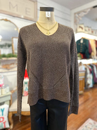 Brown sweater on a mannequin in a store setting