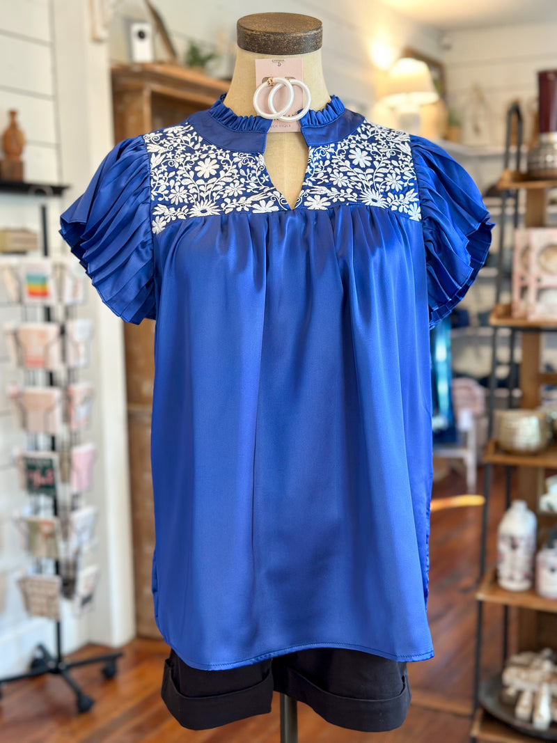 royal blue and white washco embroidered top