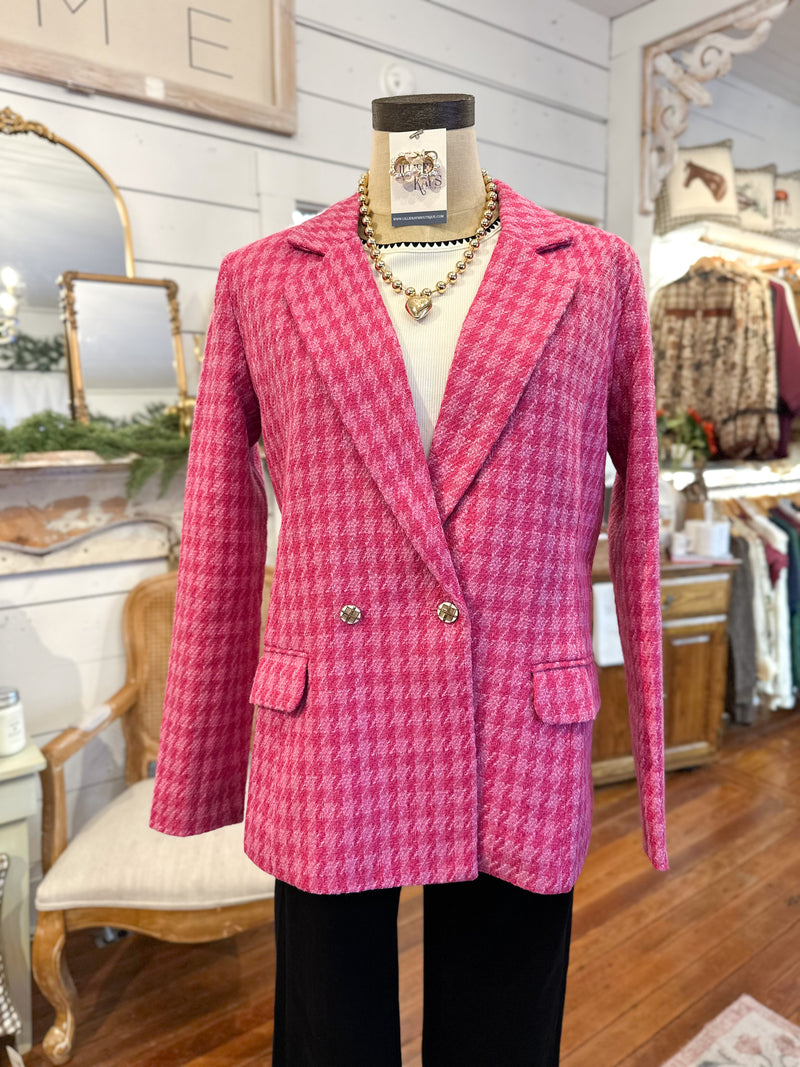 Pink houndstooth blazer on a mannequin in a store setting