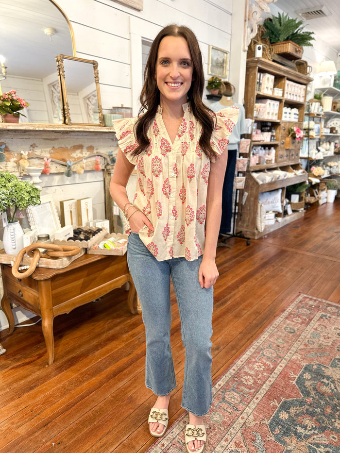 cream color flutter sleeve top with pink block print design thml