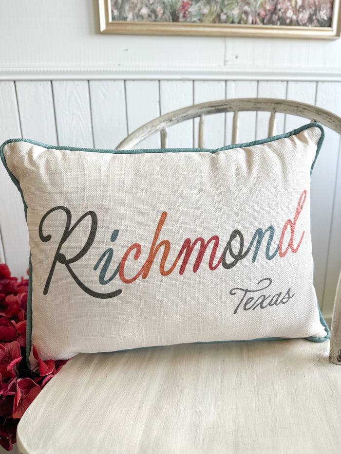 Decorative pillow with 'Richmond Texas' text on a white bench.