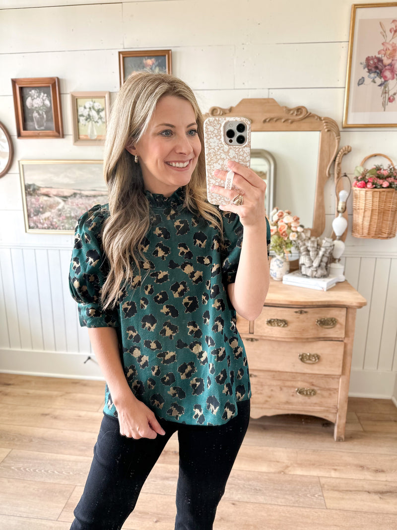 teal printed blouse with button down the back 