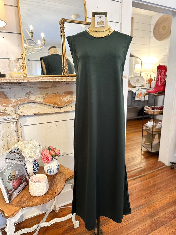 Green dress on a mannequin in a room with decor elements.