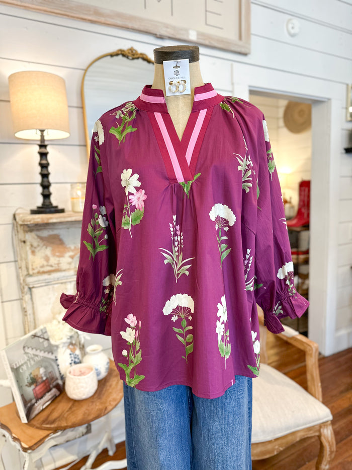 Purple floral blouse on a mannequin in a store setting. umgee floral top 