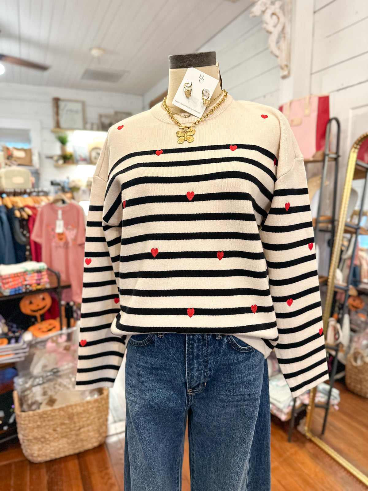 cream long sleeve sweater with black stripes and red hearts 