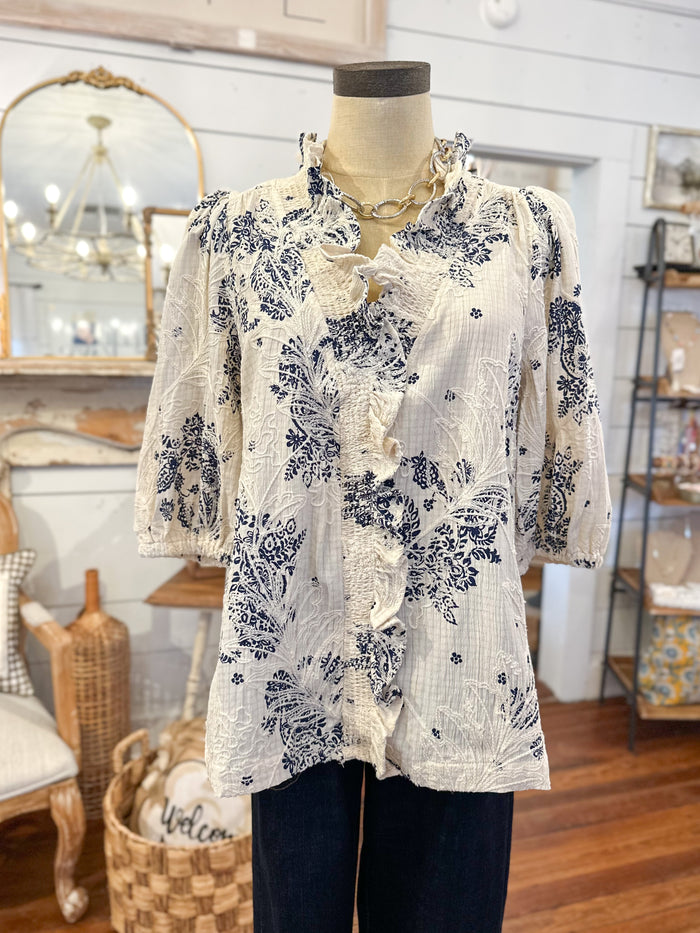 Mannequin wearing a floral blouse in a home decor store setting
