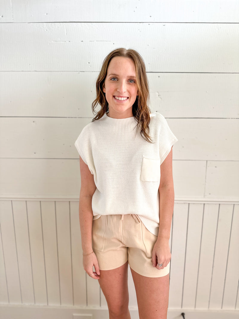 light tan color shorts with cream color sweater top