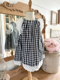 Black and white checkered dress with lace trim on a mannequin against a decorative background. toddler youth sizes 