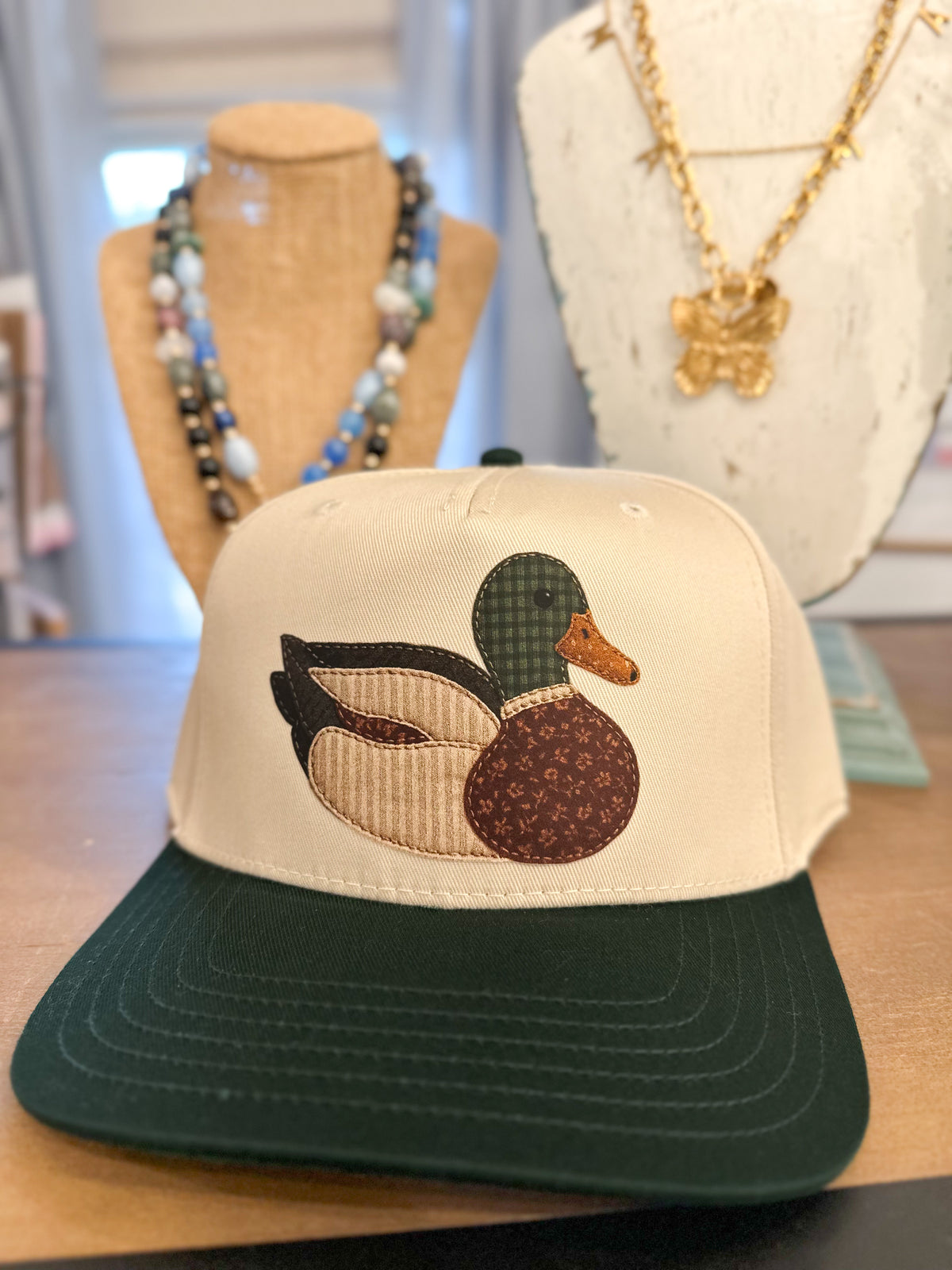 cream and green mallard duck design hat with heat press patch on the front 
