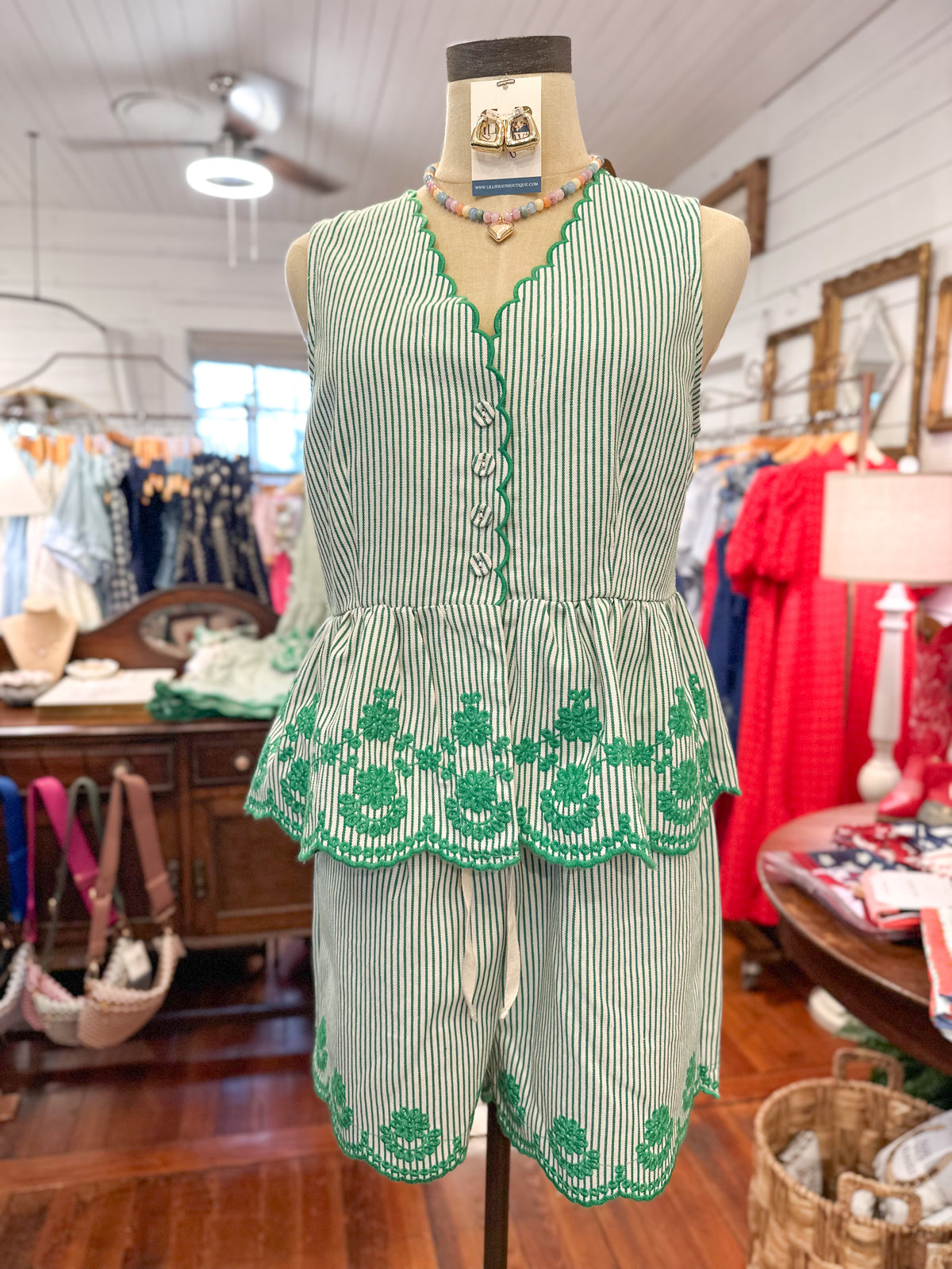 Green and white striped outfit on a mannequin in a store setting