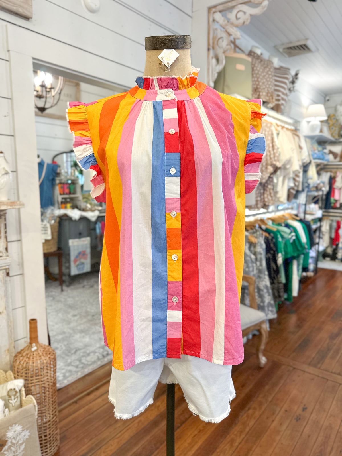 Colorful striped shirt on a mannequin in a store setting