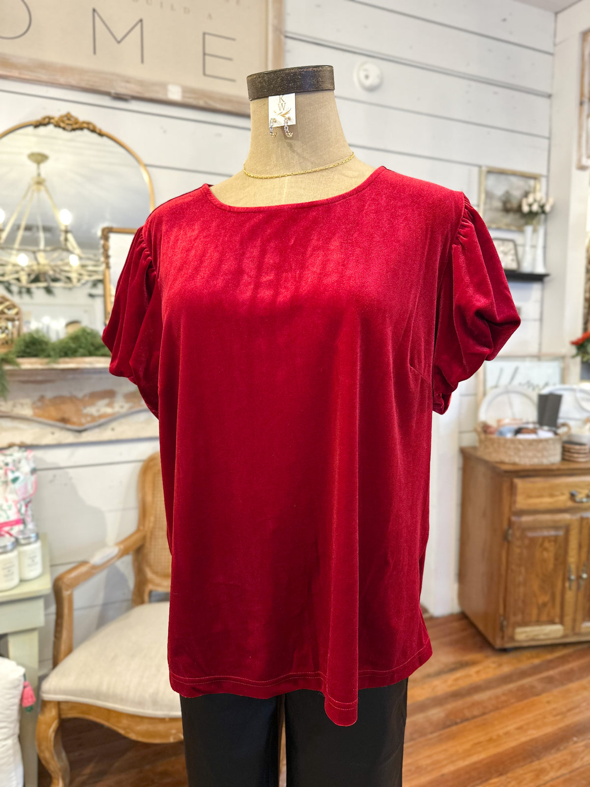 Red top on a mannequin in a home decor setting