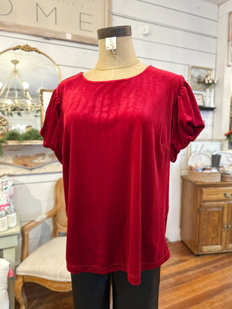 Red top on a mannequin in a home decor setting
