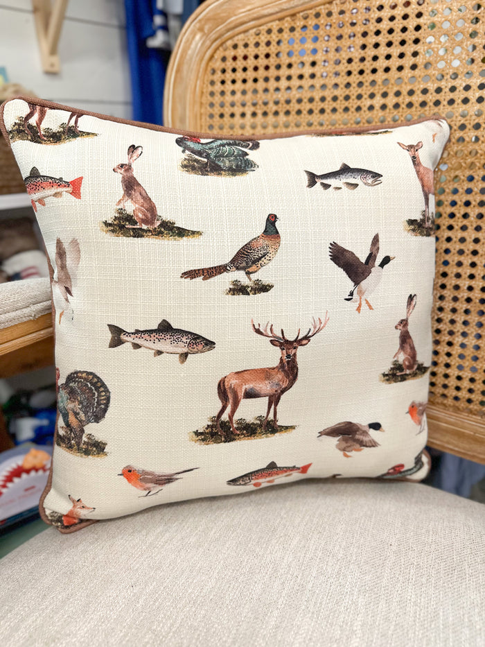 Decorative pillow with animal illustrations on a chair