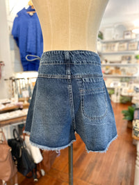 Blue denim shorts on a mannequin in a store setting