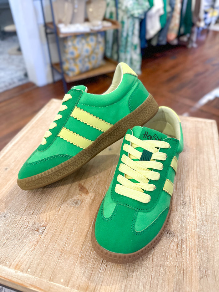 green sneaker with yellow details on the side 