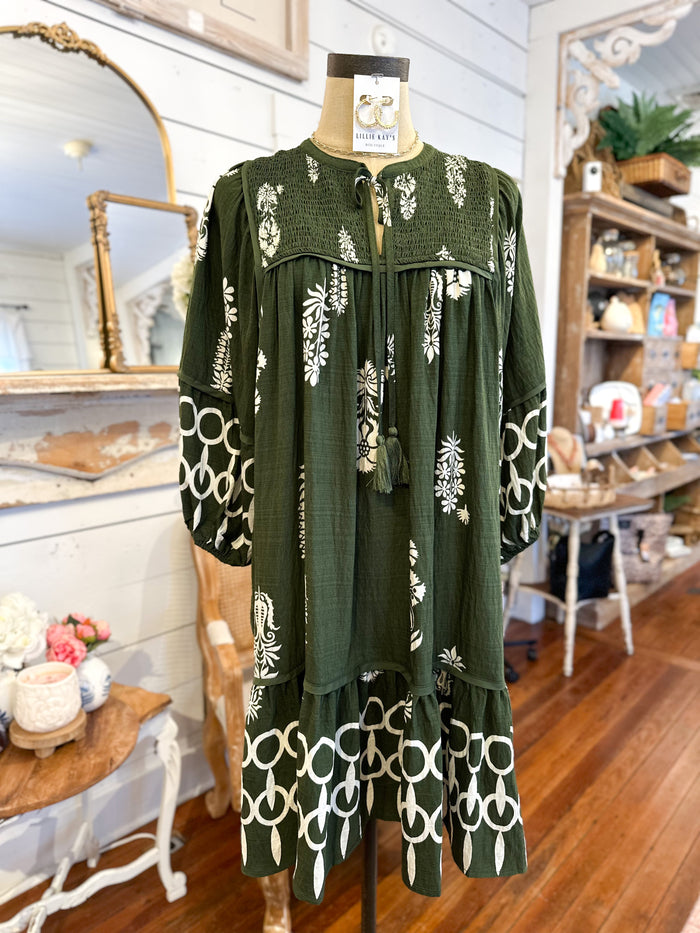 Green dress with white patterns on a mannequin in a store setting. umgee dress