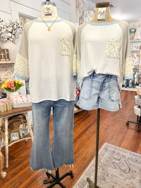 Two mannequins wearing light-colored tops and blue jeans in a store setting.