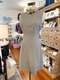 brown plaid sleeveless dress in store setting 