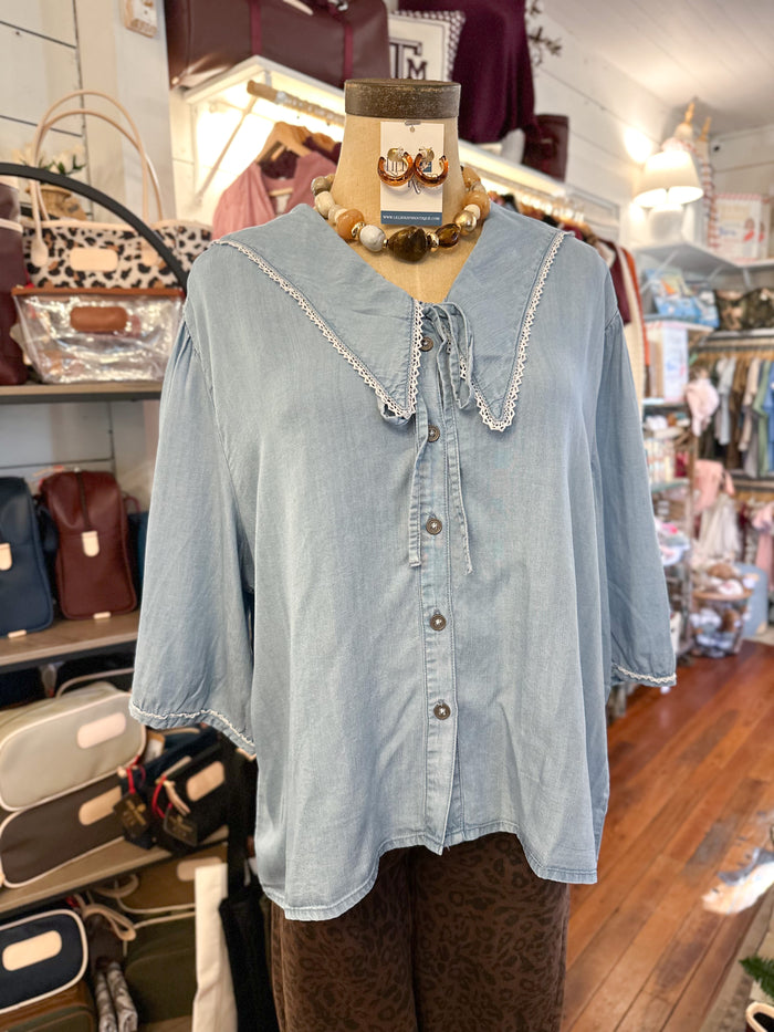 light blue peter pan collar blouse in store setting 