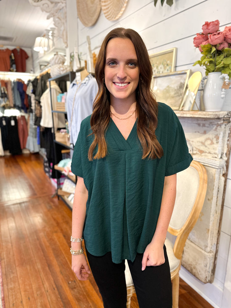 dark green rolled sleeve top with flowy fit 