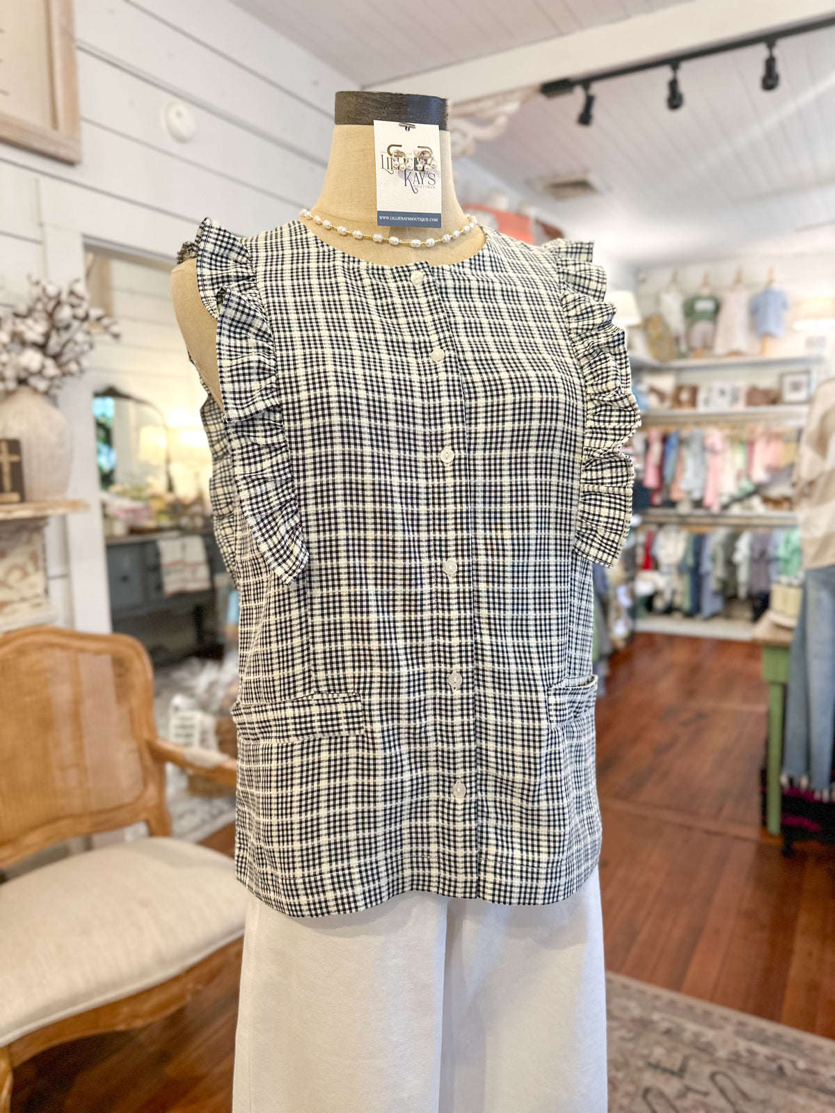 Black and white checkered top on a mannequin in a store setting