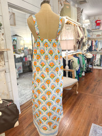 Mannequin wearing a floral dress in a store setting back of dress