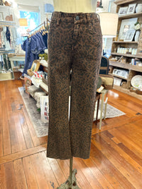 Brown and black leopard print wide-leg jeans displayed on a mannequin in a retail store.