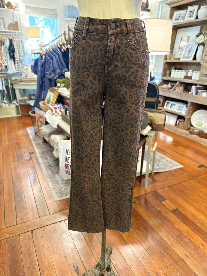 Brown and black leopard print wide-leg jeans displayed on a mannequin in a retail store.
