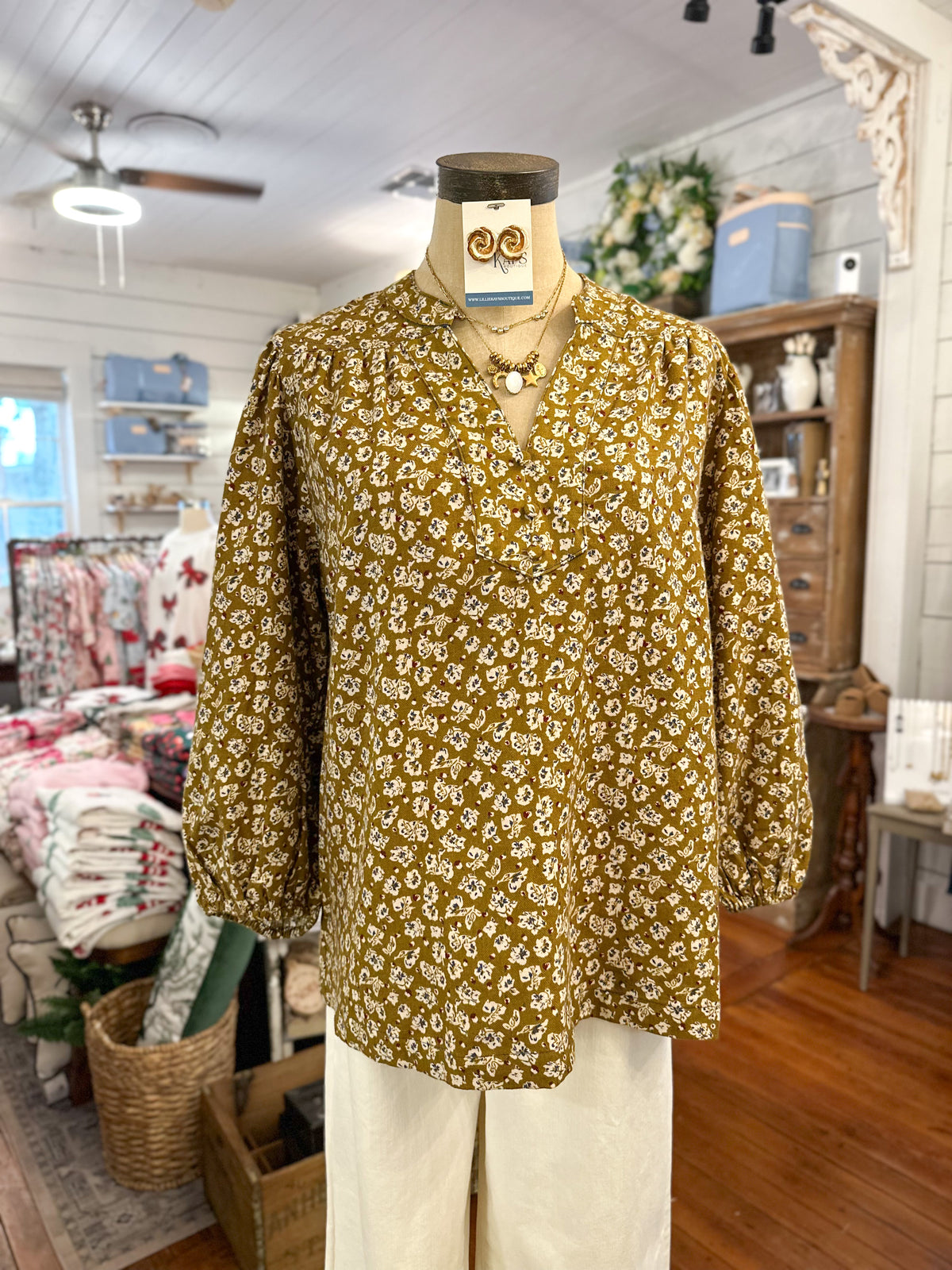 corduroy floral fall blouse umgee with long sleeves inside store setting 