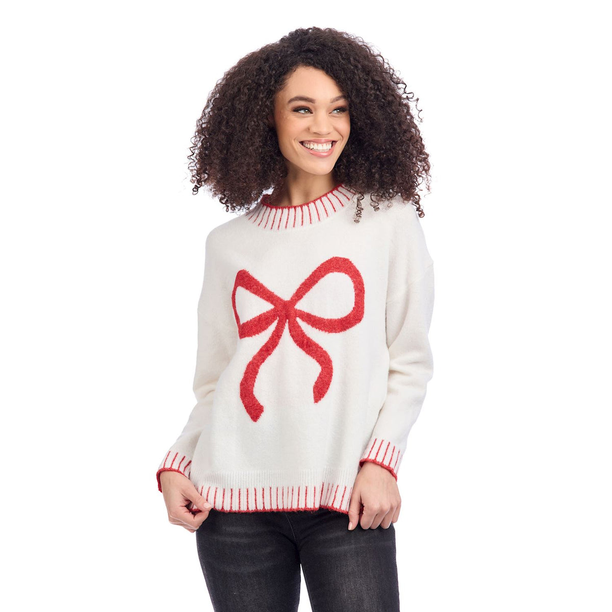 Woman wearing a white sweater with a red bow design on a white background