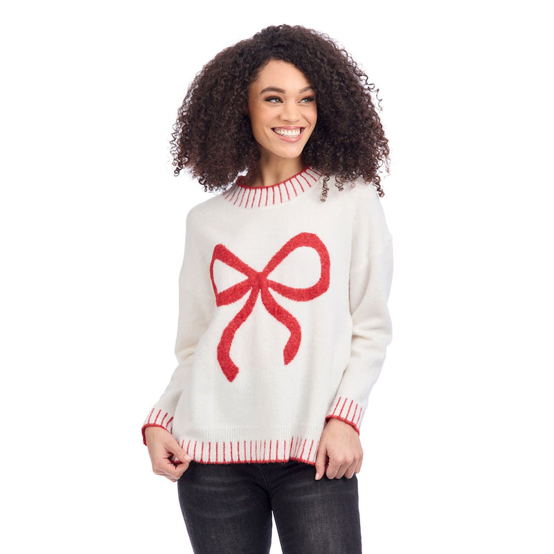 Woman wearing a white sweater with a red bow design on a white background