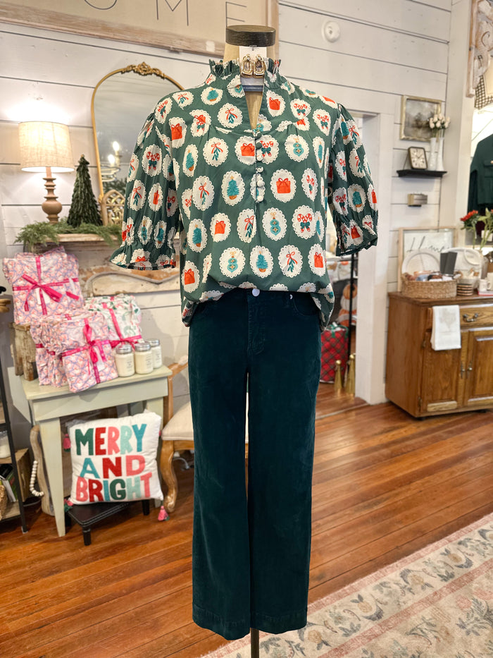 Mannequin wearing a patterned shirt and dark pants in a home interior  layerz holiday ornament top 