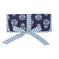 Navy ribbon with floral pattern and blue striped bow on a white background