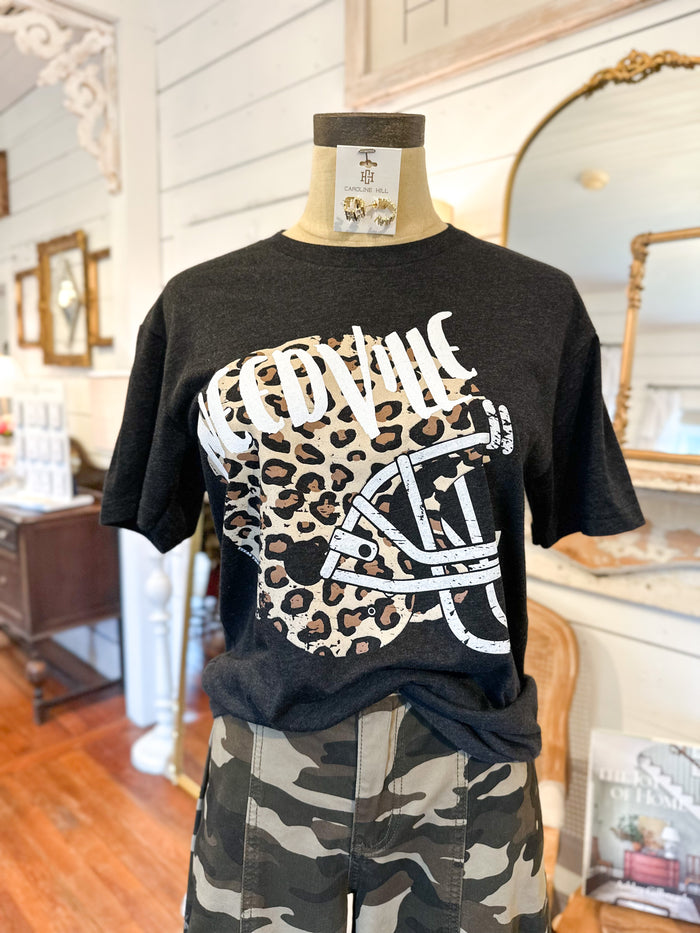 Black t-shirt with leopard print design on a mannequin in a store setting
