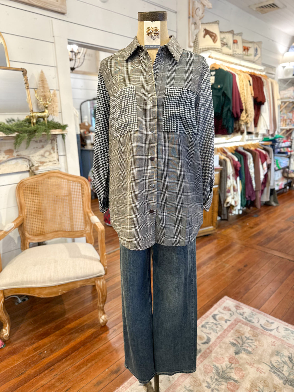 Mannequin wearing a plaid shirt and jeans in a store setting