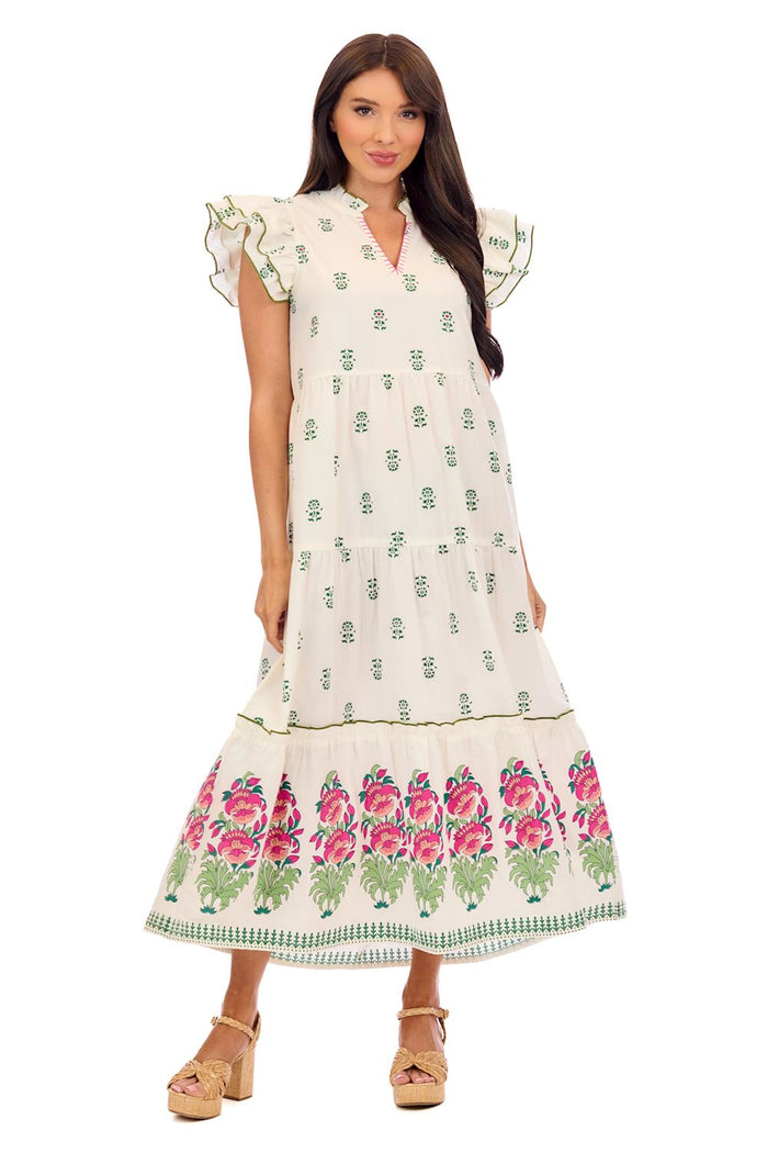 Woman wearing a white dress with floral patterns on a white background mud pie welton dress
