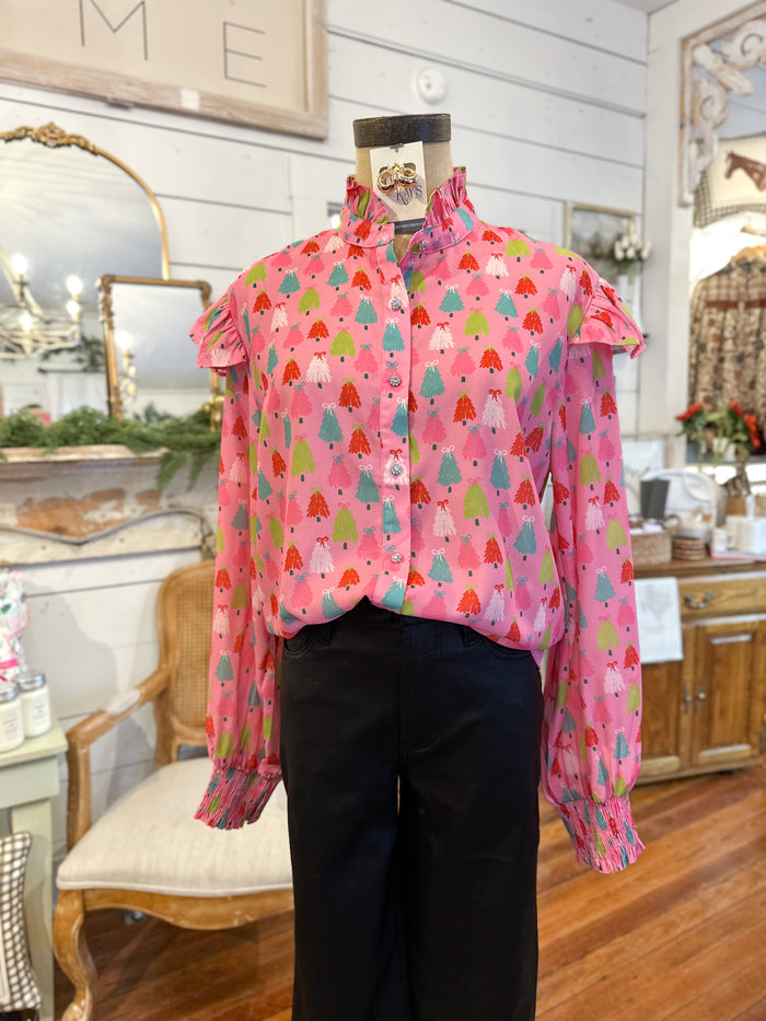 Mannequin wearing a pink blouse with colorful patterns in a store 
Layerz clothing caroline top