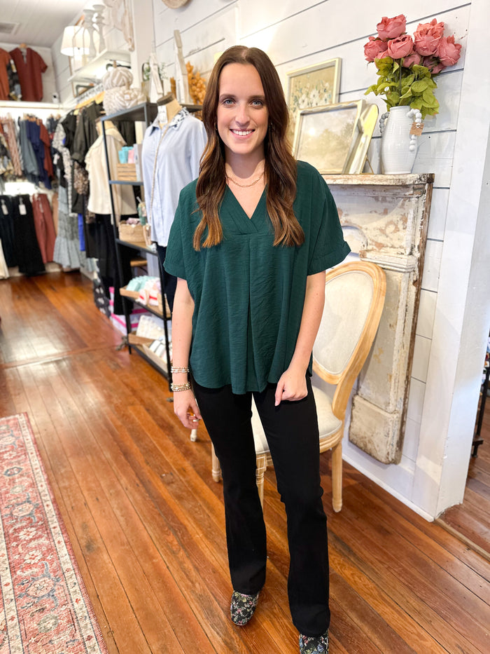 dark green rolled sleeve top with flowy fit 